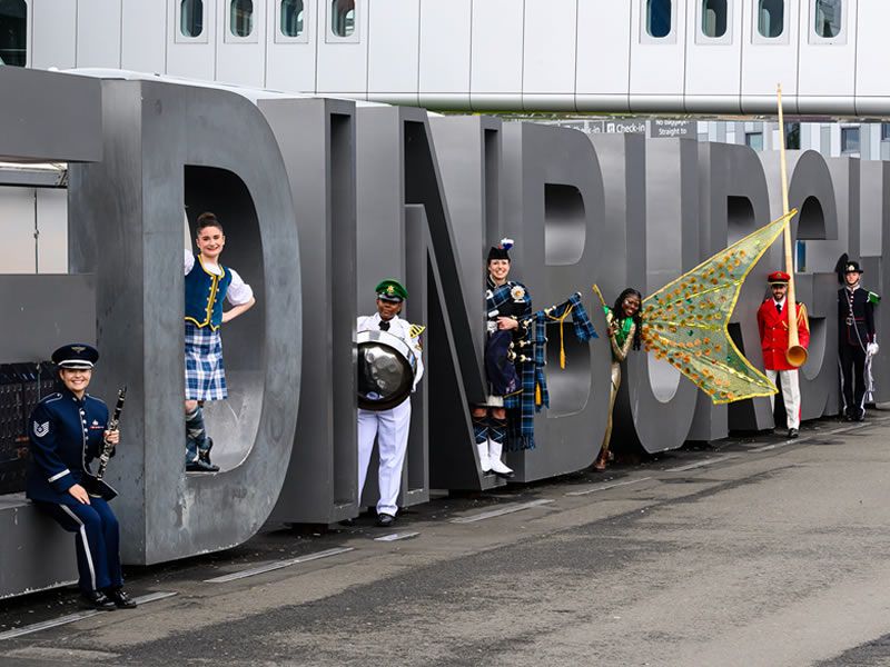 Warm Scottish welcome for The Royal Edinburgh Military Tattoo Cast as they arrive in the capital